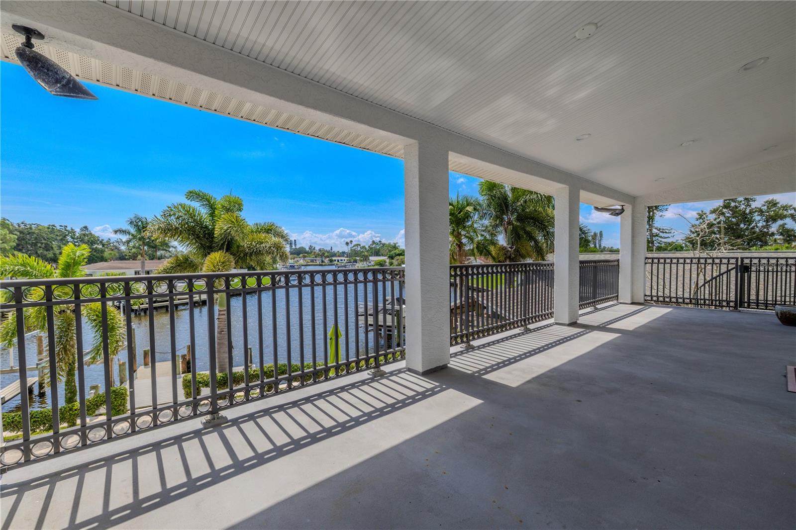 The expansive 330 sq. ft. covered balcony off the primary suite offers breathtaking panoramic views of the wide canal.