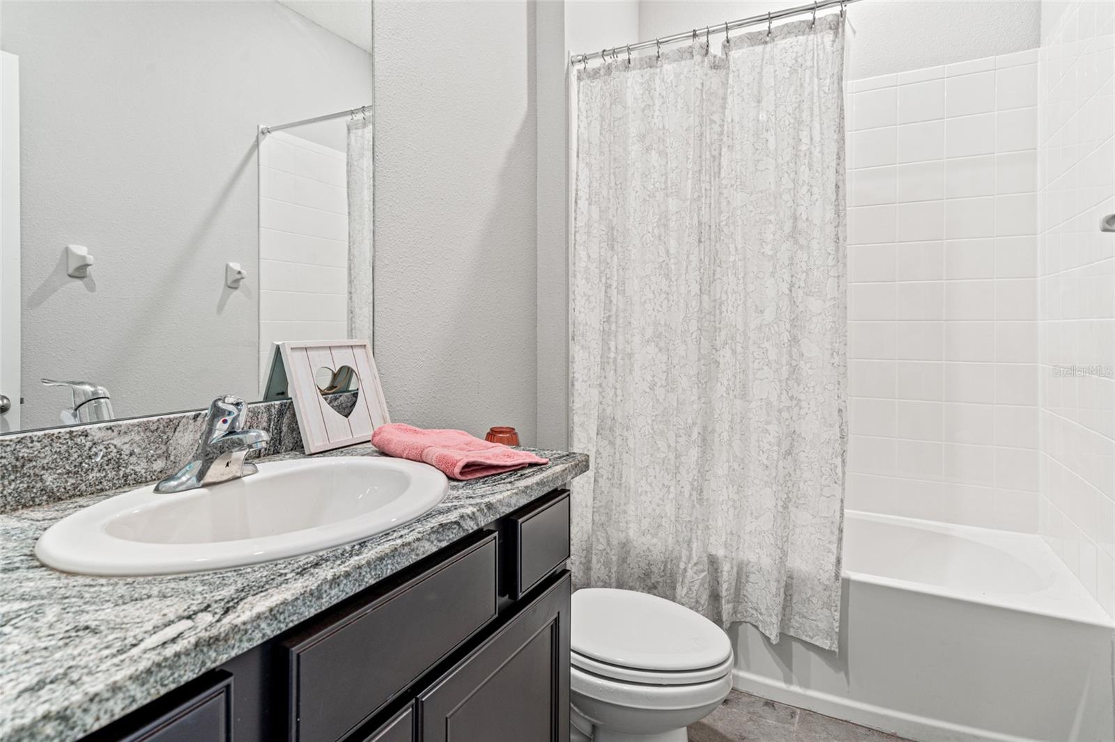 spacious secondary bath with tub and shower