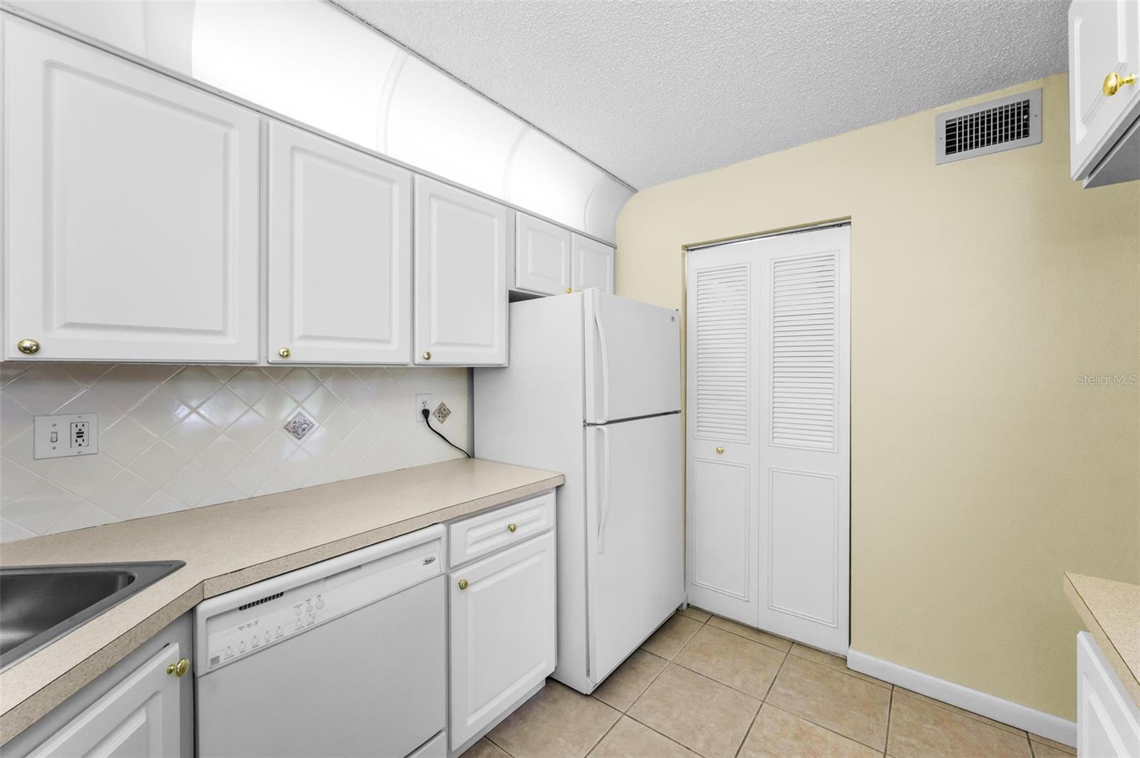 Kitchen with view of laundry closet