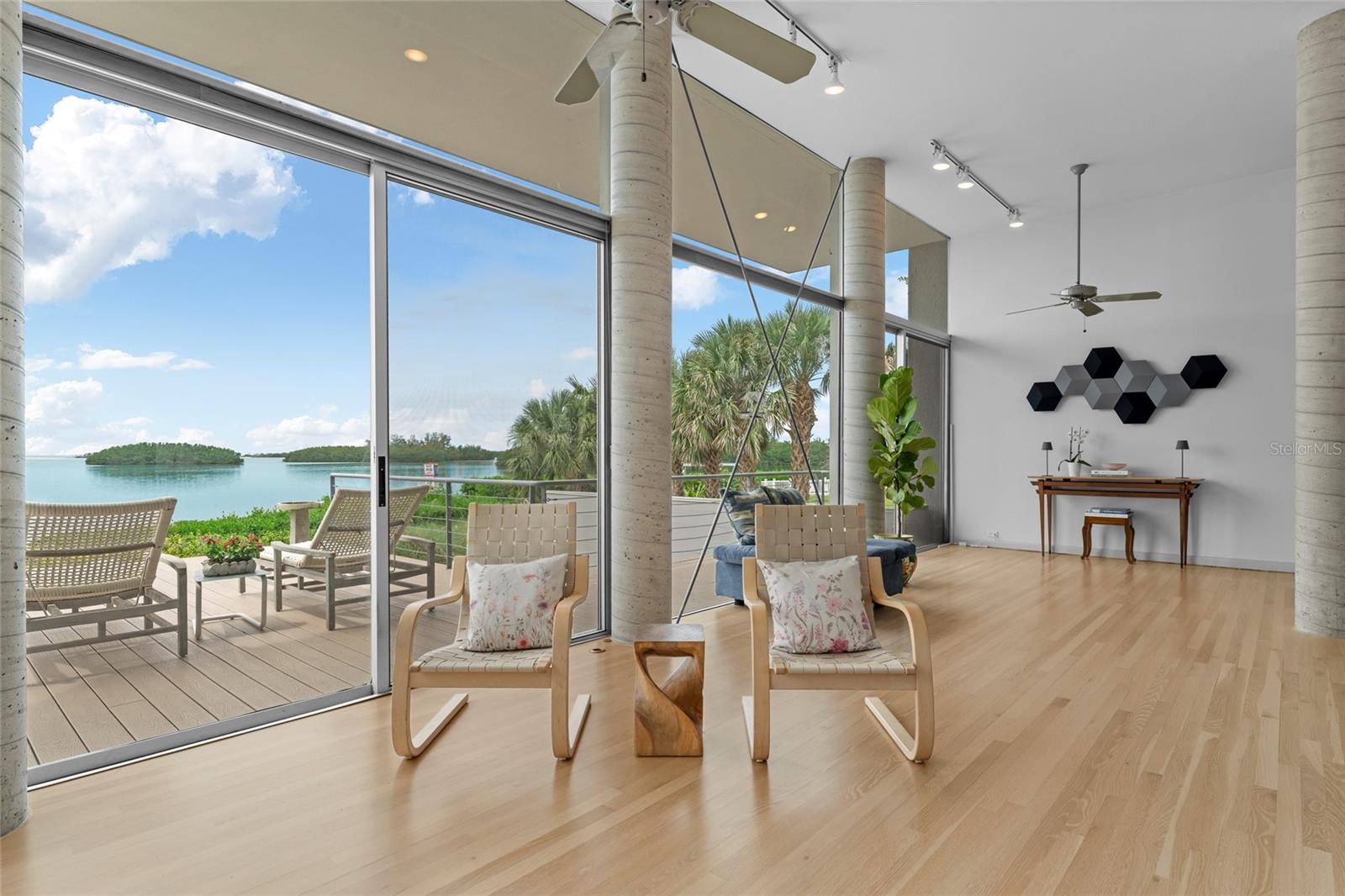 Living area with magnificent waterfront views and expansive window sliders with beachfront access