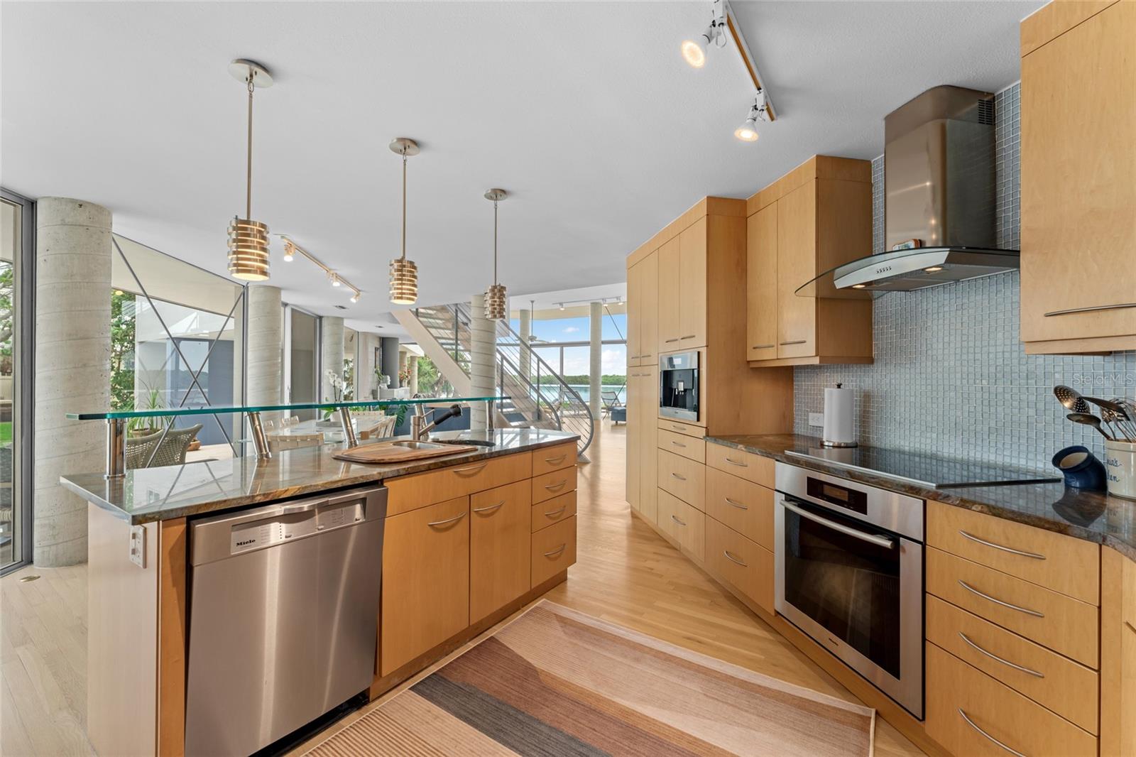 The kitchen flows effortlessly into the living and entertaining areas, creating a space designed for comfort and ease
