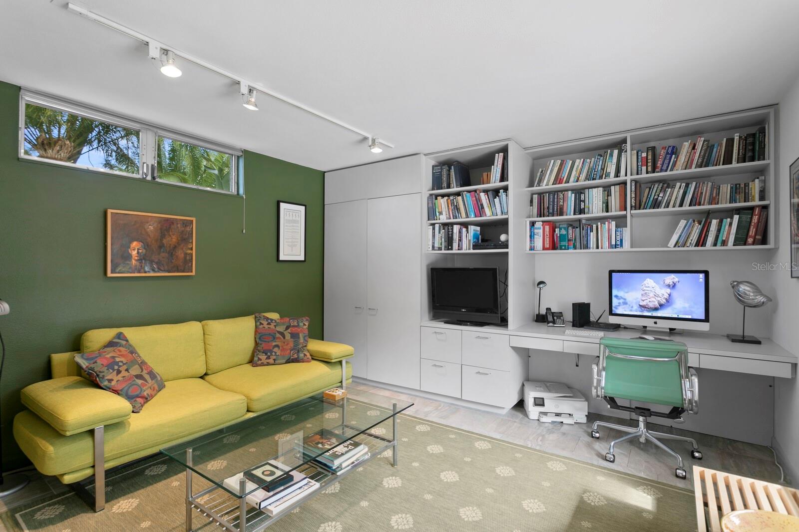 Versatile study or library with built-in shelving and workspace. Also counts as a second bedroom with a closet and full bathroom.