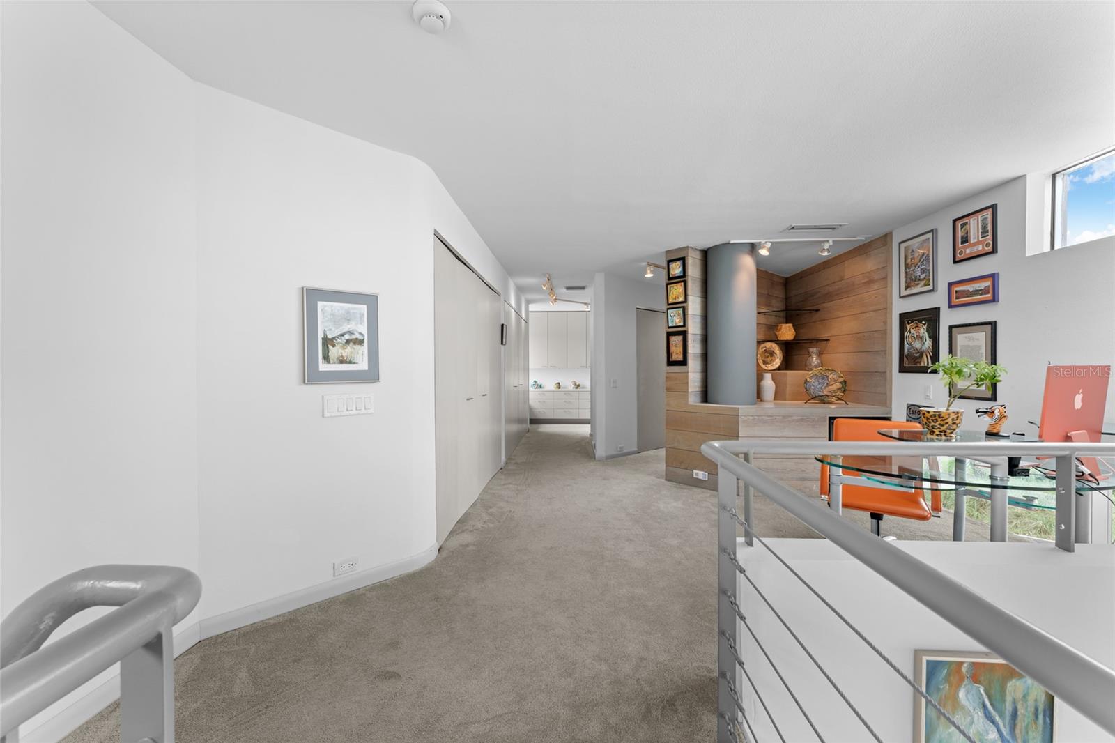 Versatile loft or workspace, ideal as a primary bedroom sitting area with captivating Gulf views.