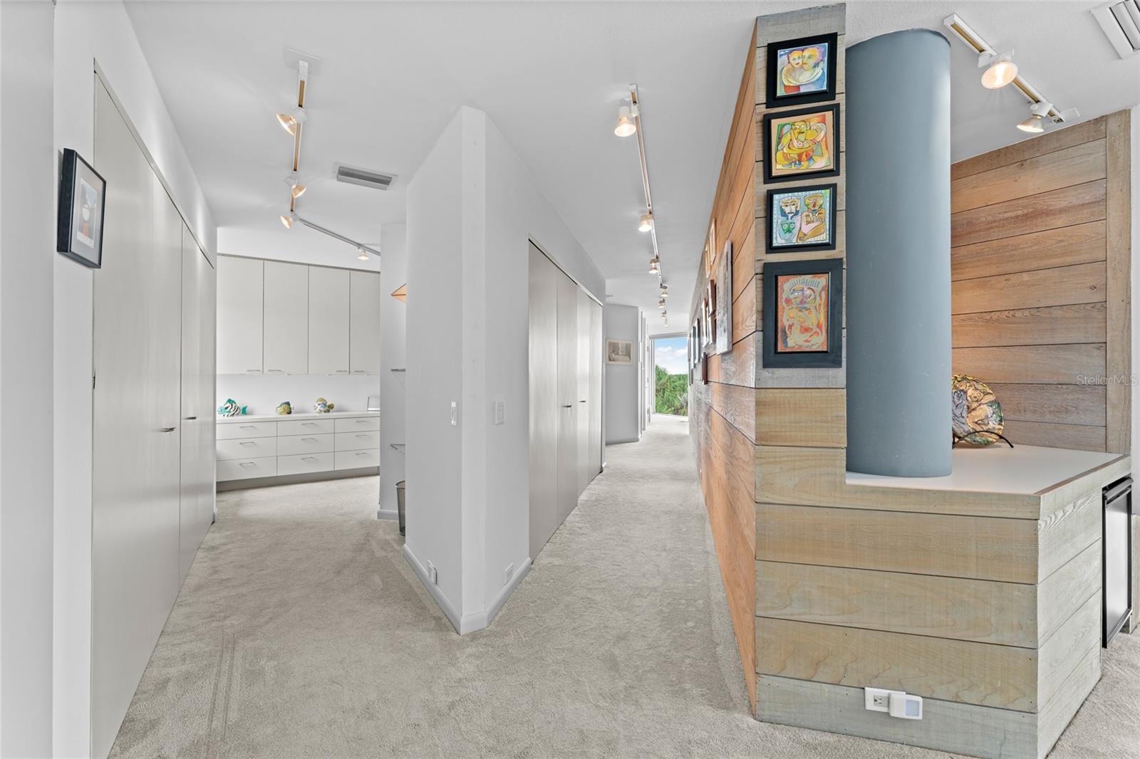 A welcoming hallway leads to the primary bedroom, offering the perfect gallery wall for showcasing your personal collection of family and friends’ photos