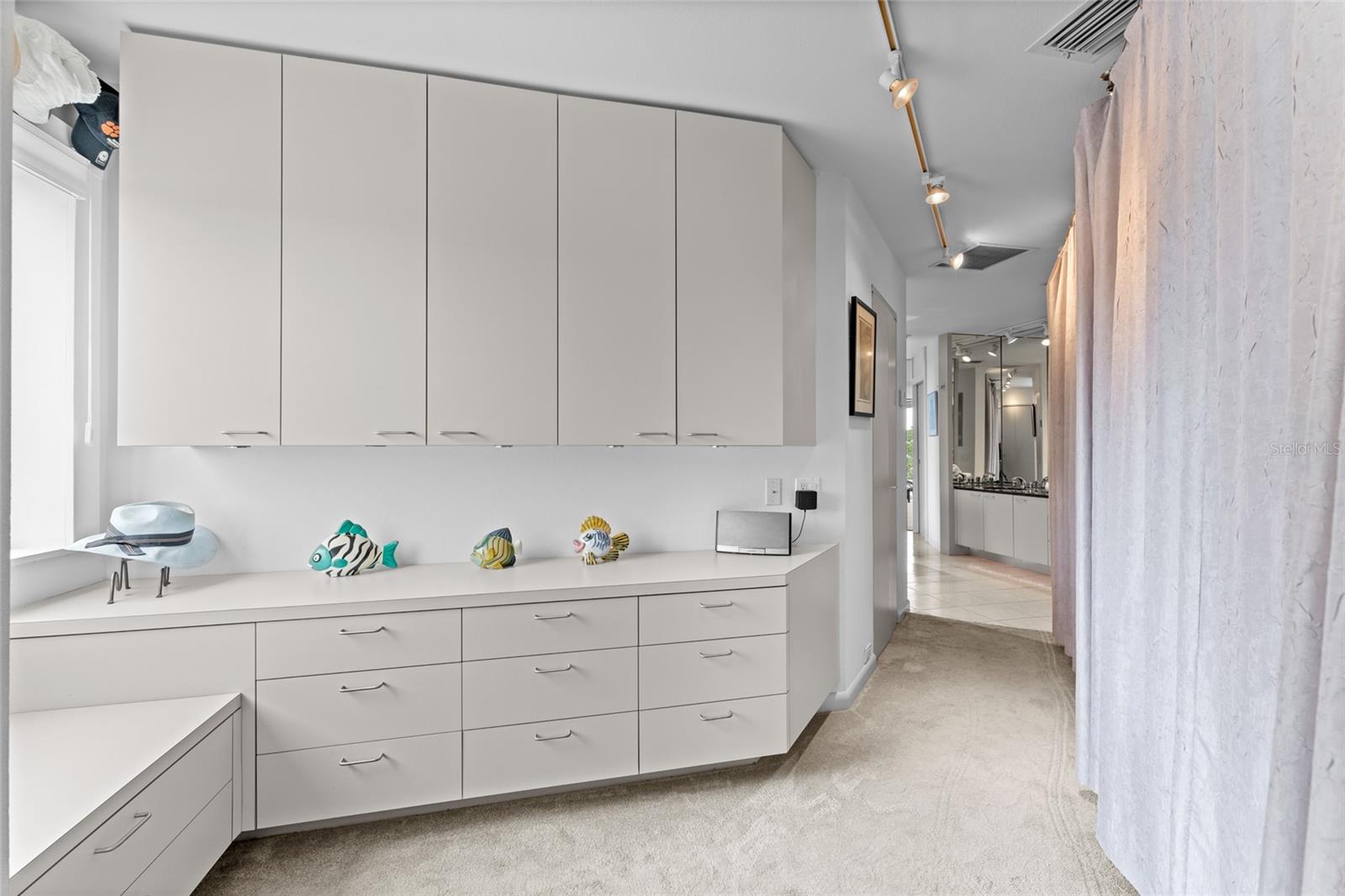 The primary bathroom begins with custom cabinetry and offers ample space to reimagine in your own modern design.
