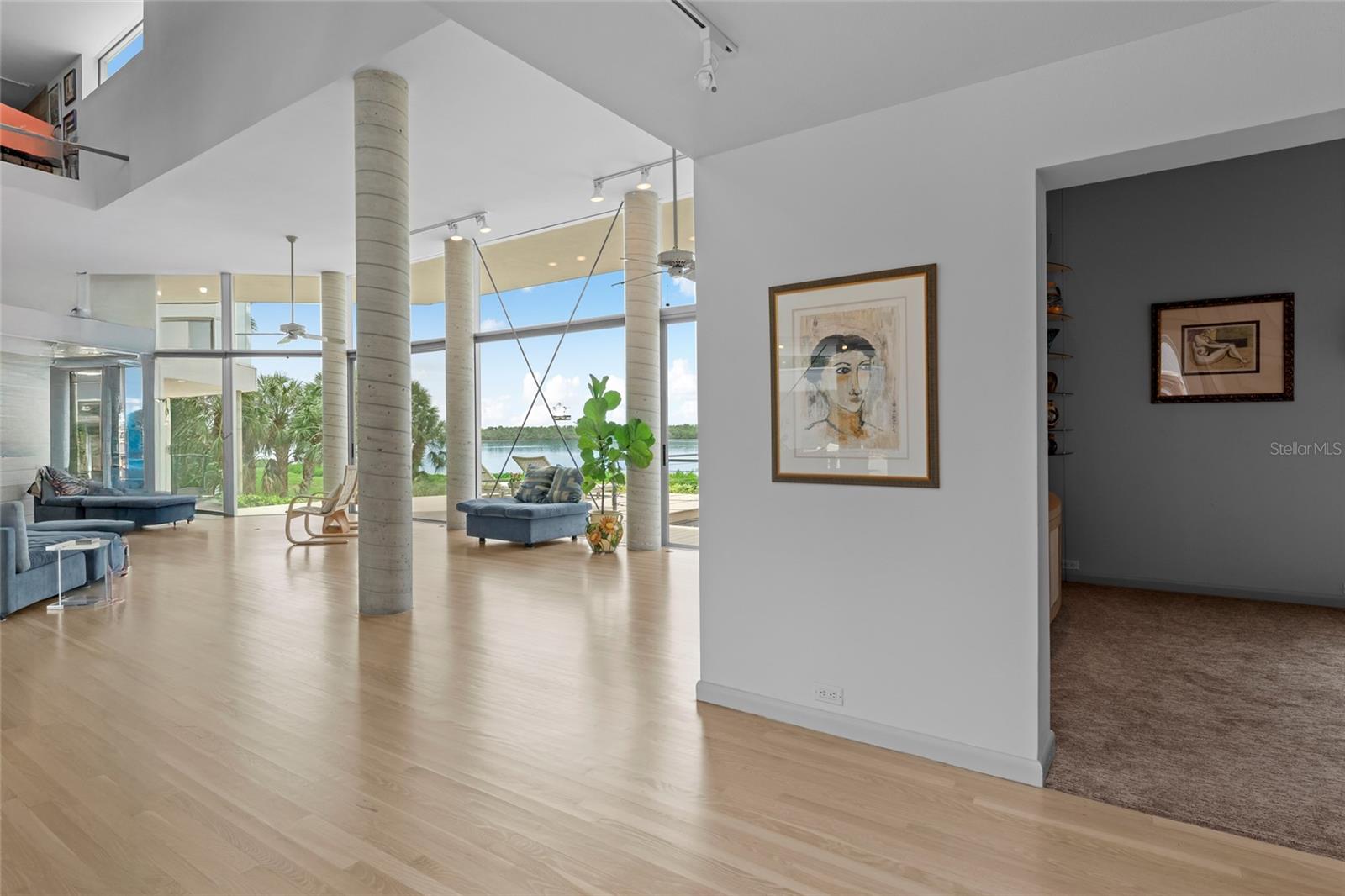 Step inside to sunlit, open living spaces beautifully framed by architectural columns.
