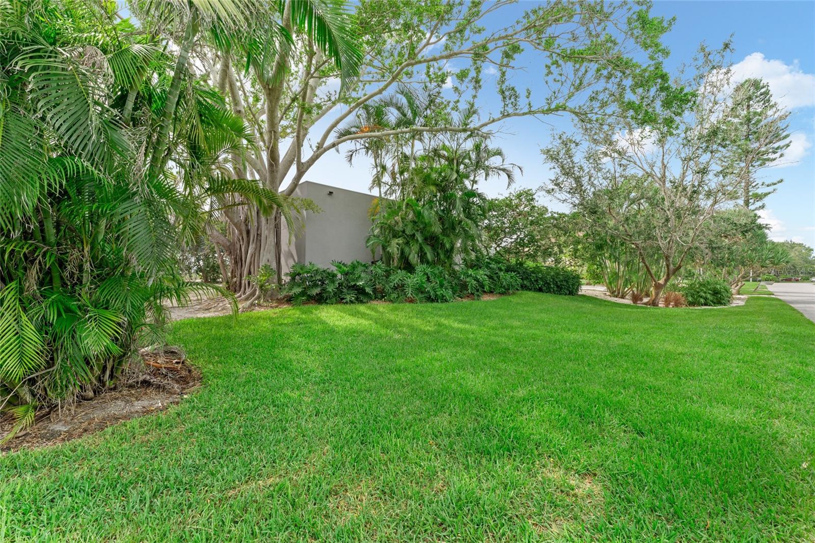 Expansive front yard with manicured grass greets you as you arrive!