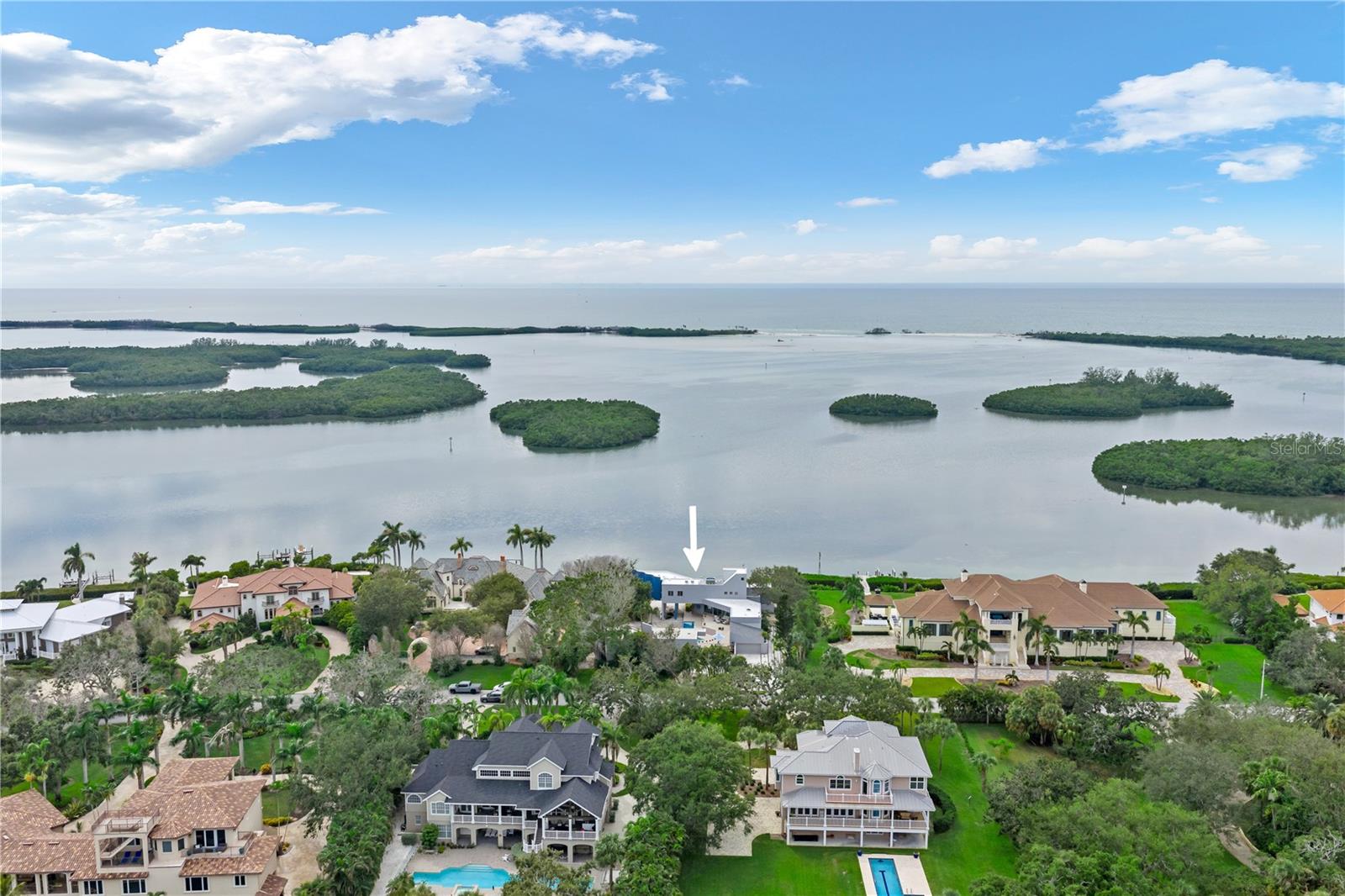 Surrounded by multimillion-dollar estates, this home features 150 feet of waterfront, on nearly 1 acre of property.