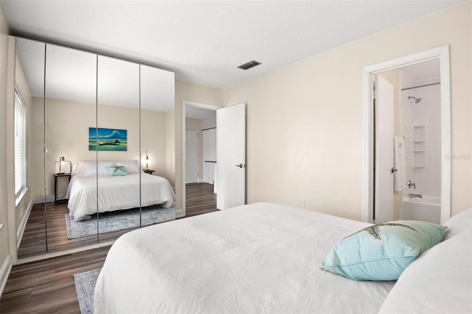 Mirrored Closet & Ensuite Bath with newly updated shower and bathtub.