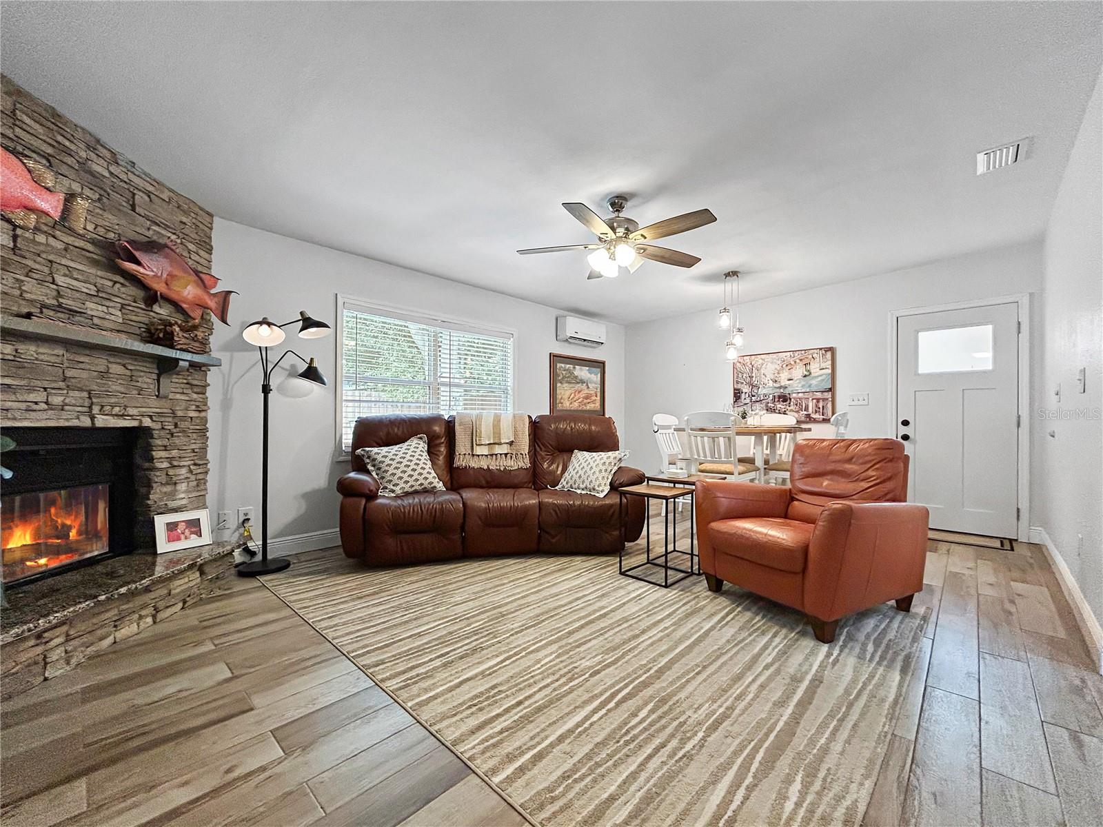 LARGE FAMILY ROOM WITH DINING AREA AND FIREPLACE