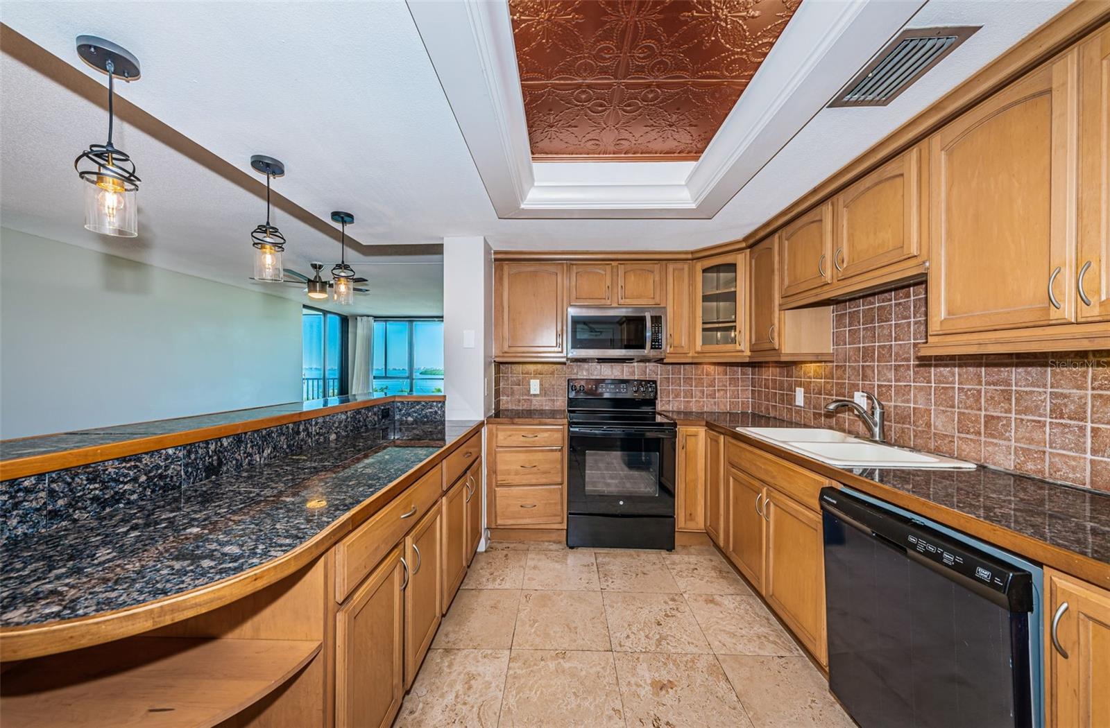 Kitchen with natural wood cabinets, new lighting, granite in-lay counter tops
