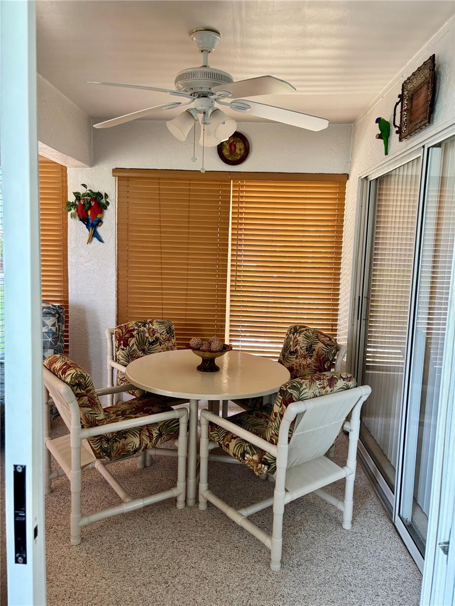 Florida room with sliding doors into guest bedroom