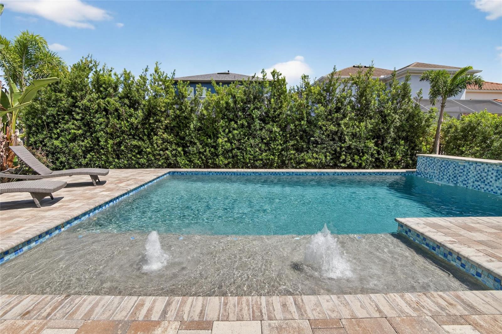Pool with waterfalls and chair deck with fountains