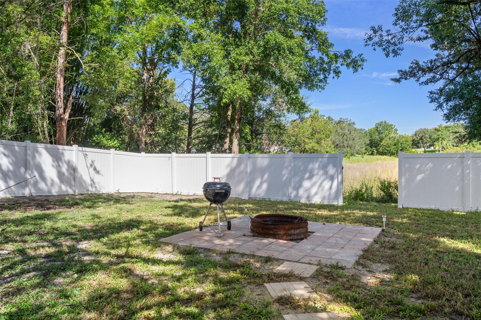 Back gate open leading to lake in rear of home