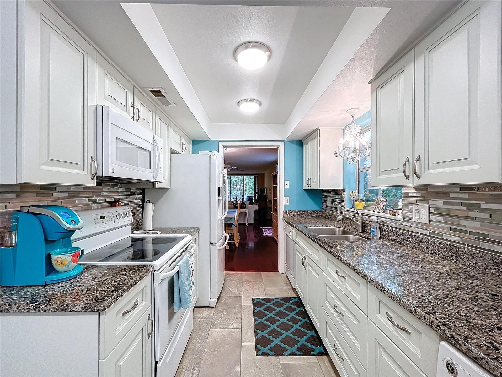 Extended countertops and cabinetry on both sides provide excellent flow and workspace, perfect for home chefs or entertaining.