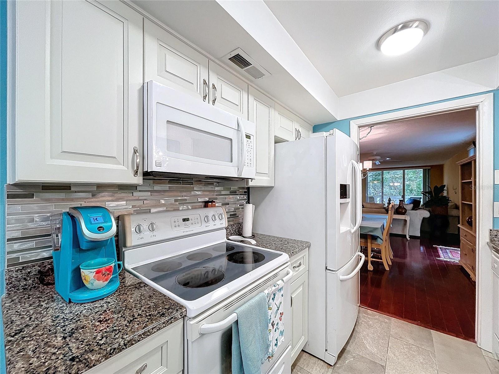 Clean, well-maintained appliances and tasteful backsplash design create a polished, move-in-ready look.
