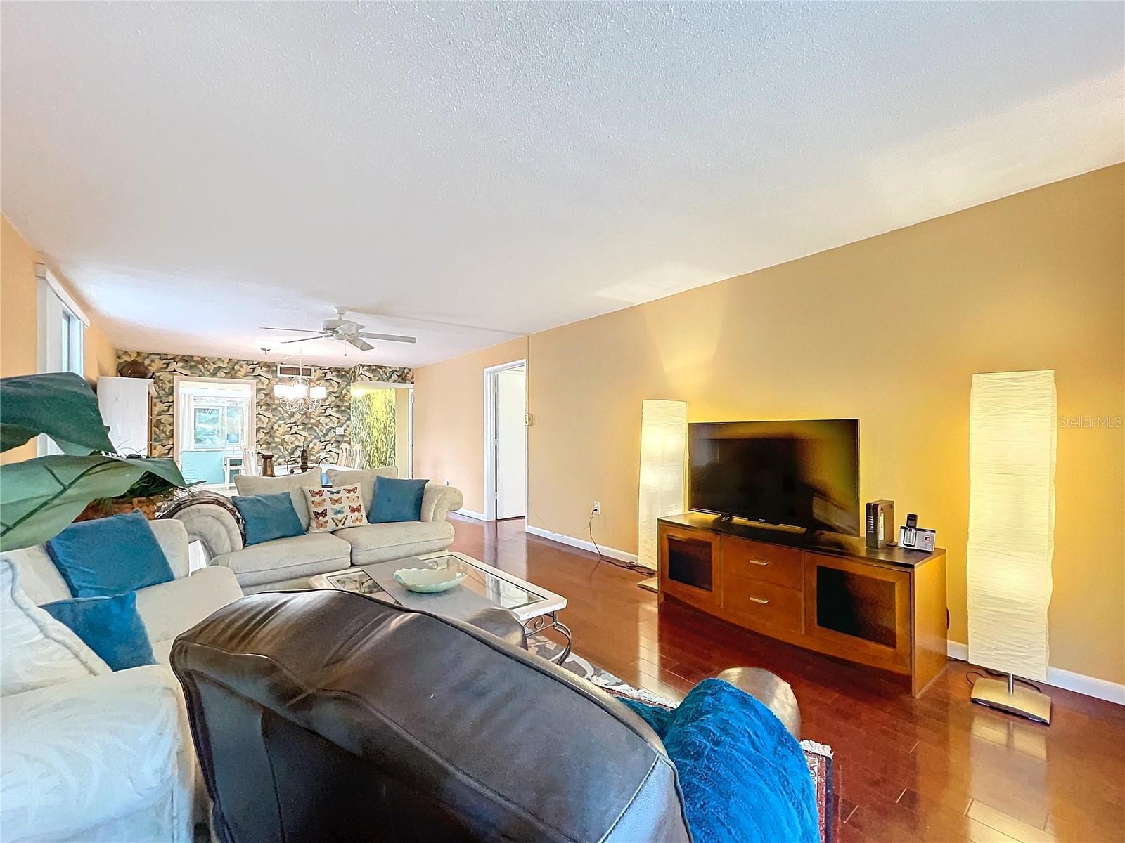 This cozy media space includes a TV nook, soft lighting, and expansive seating—ideal for everyday relaxation or entertaining.