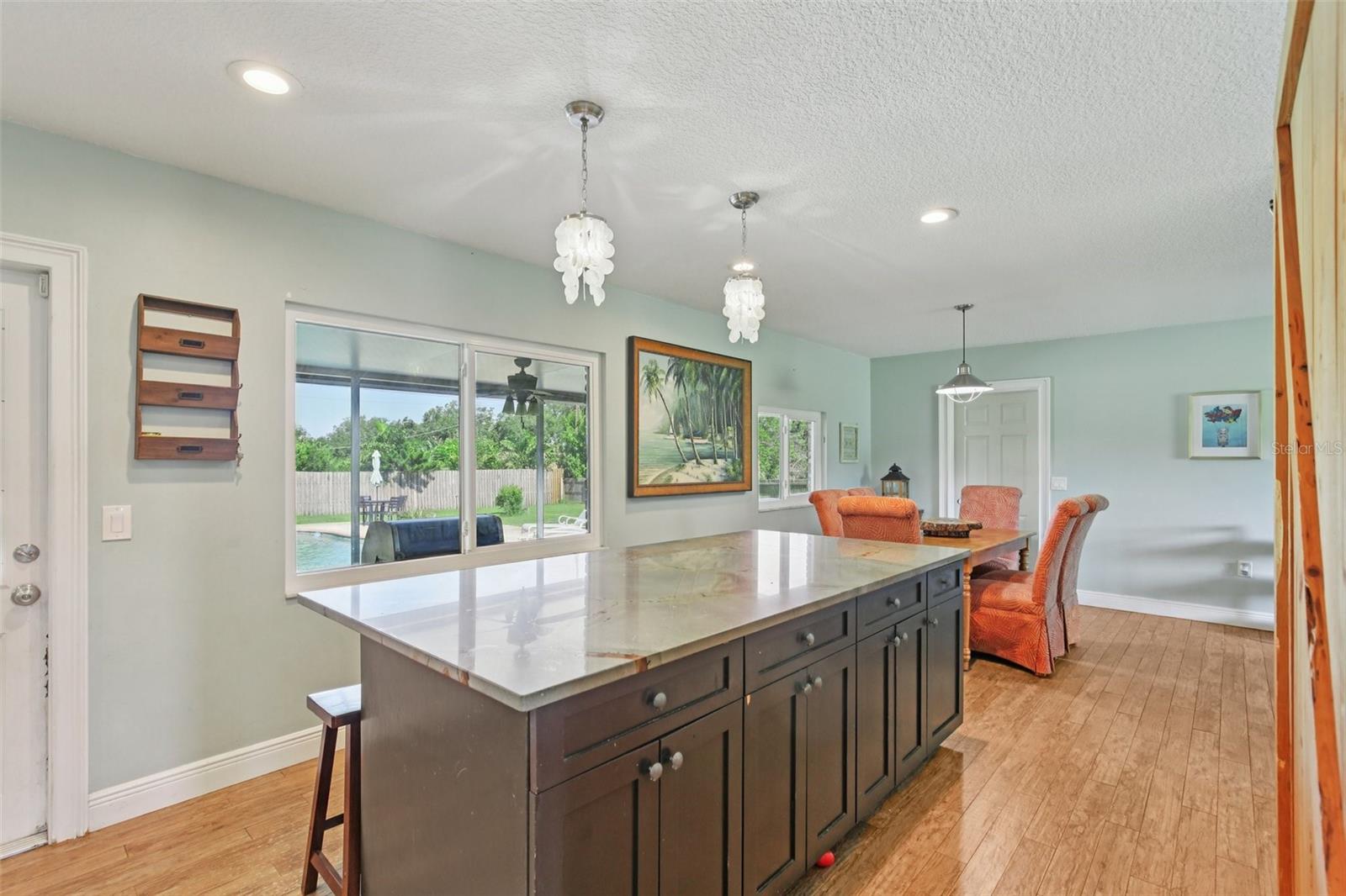 Island with cabinets and seating area
