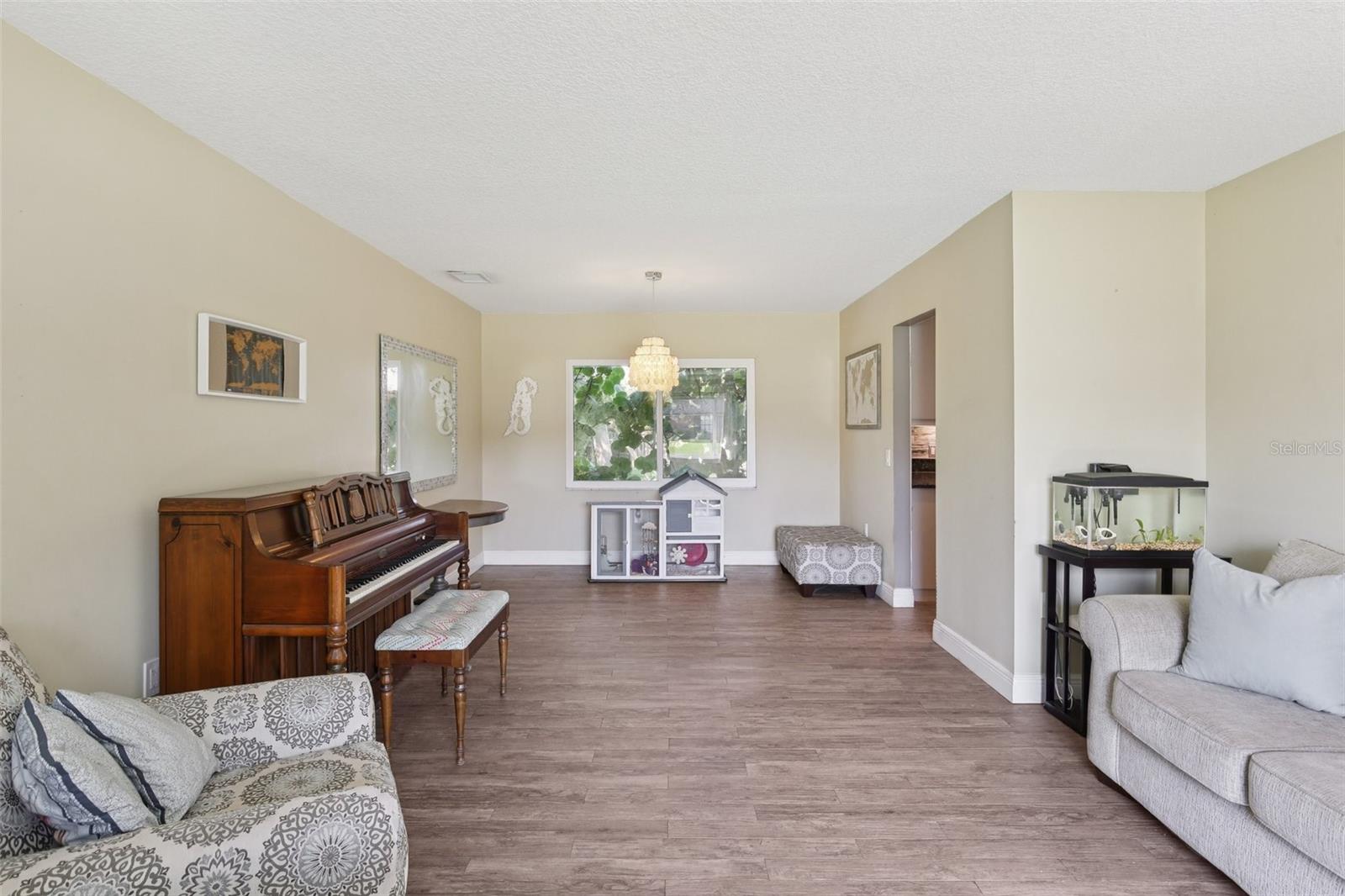Dining Room/Living Room combo with wood look tile throughout the downstairs.