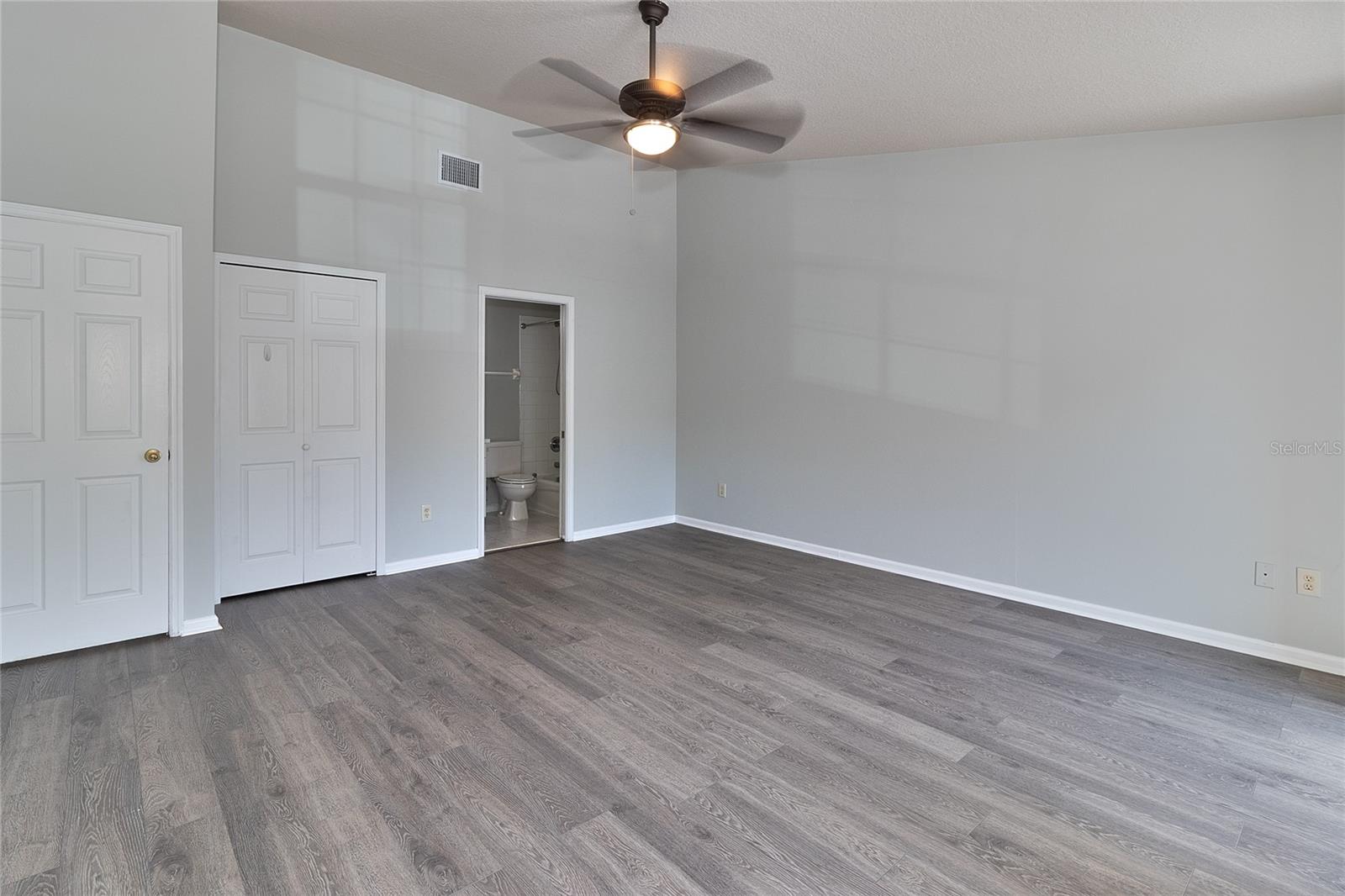 Another view of primary bedroom. Entry door closed on left.