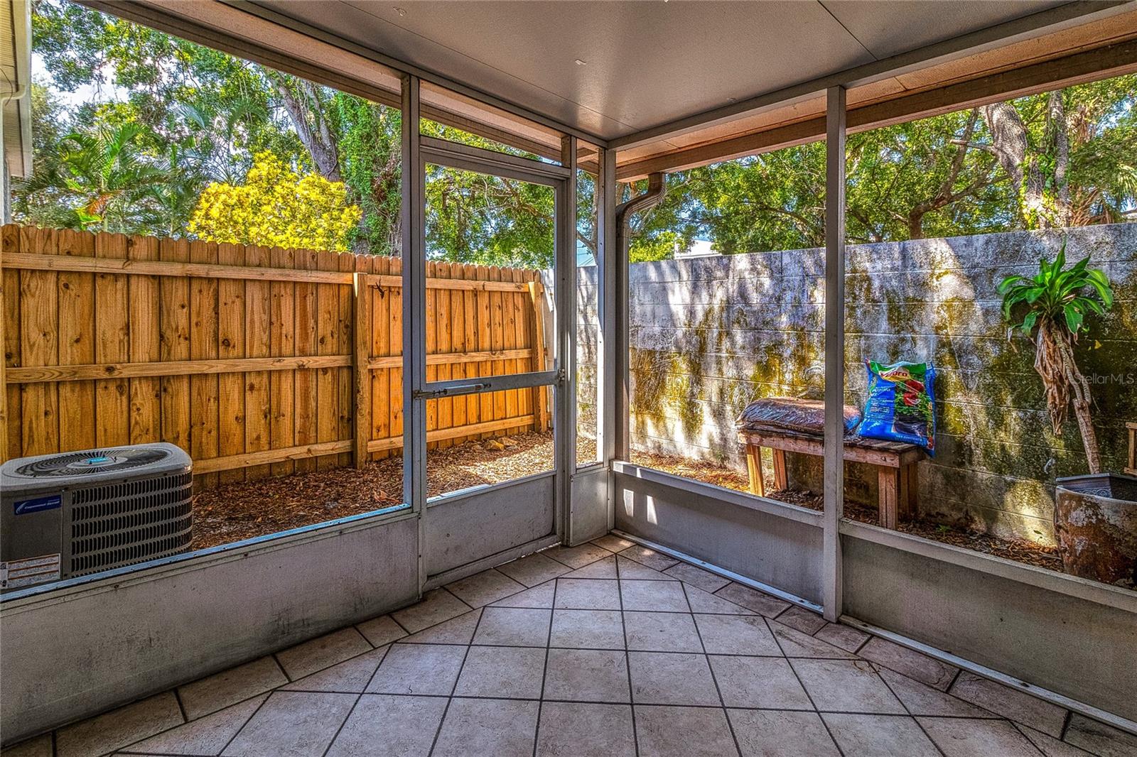 Other side of lanai with small yard area.