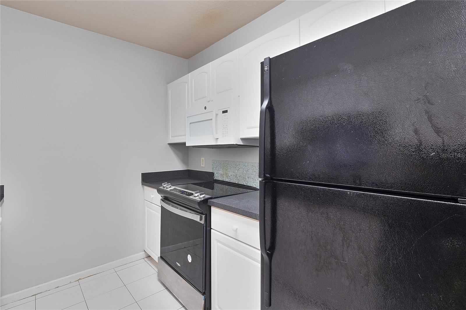 Right side of kitchen showing range & microwave.