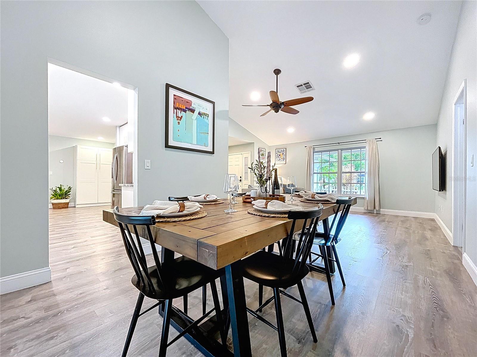 Central dining area conveniently situated between the kitchen and living space, providing great sightlines and functionality.
