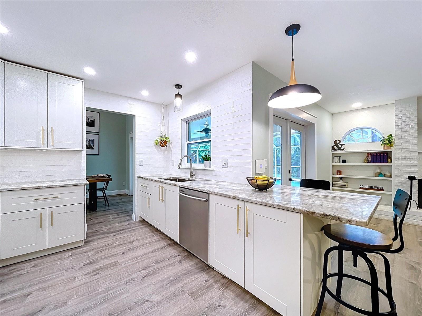 Additional view showcasing the extended breakfast bar with pendant lighting—perfect for casual meals or morning coffee.