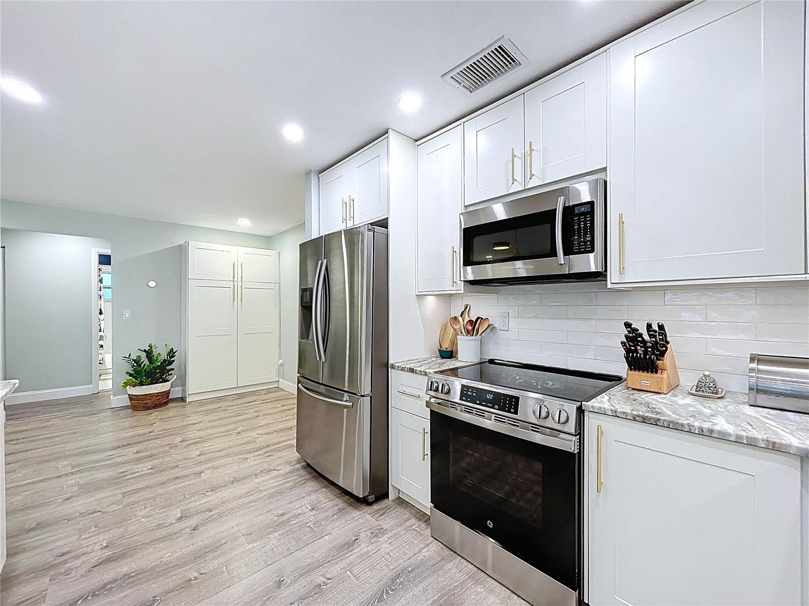 Bright and spacious kitchen includes a built-in pantry wall and stylish finishes, ideal for everyday convenience and entertaining.
