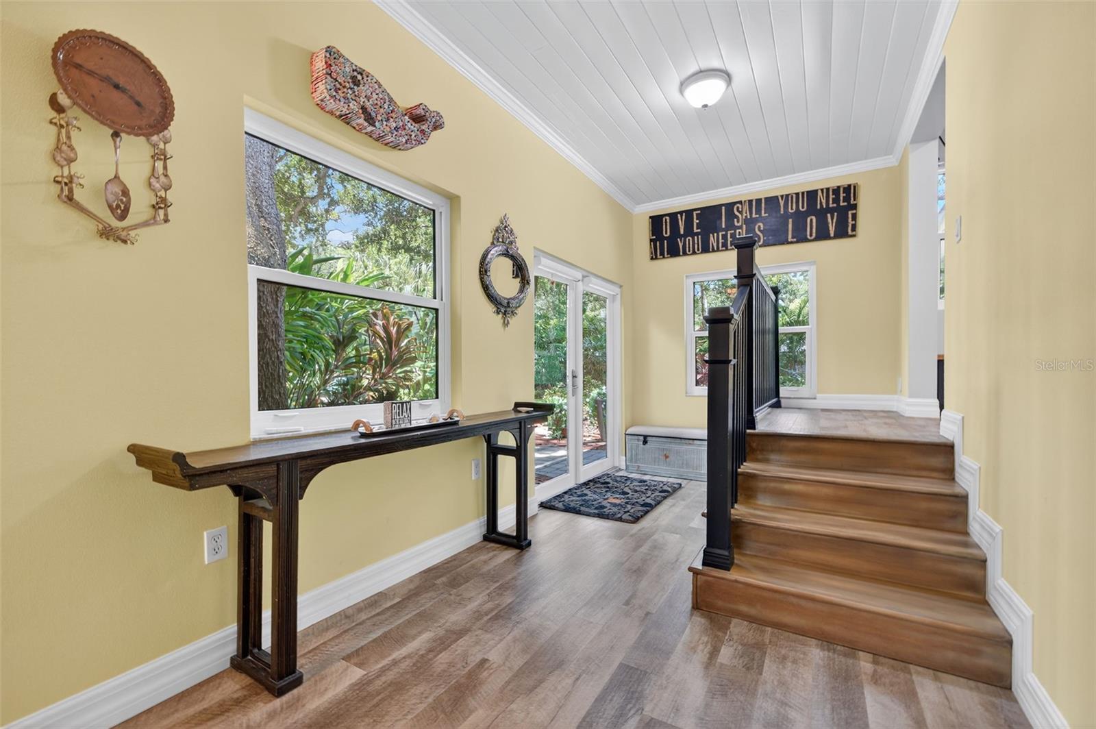 Family room; Breezeway with French Doors to the Tropical Oasis in the Backyard