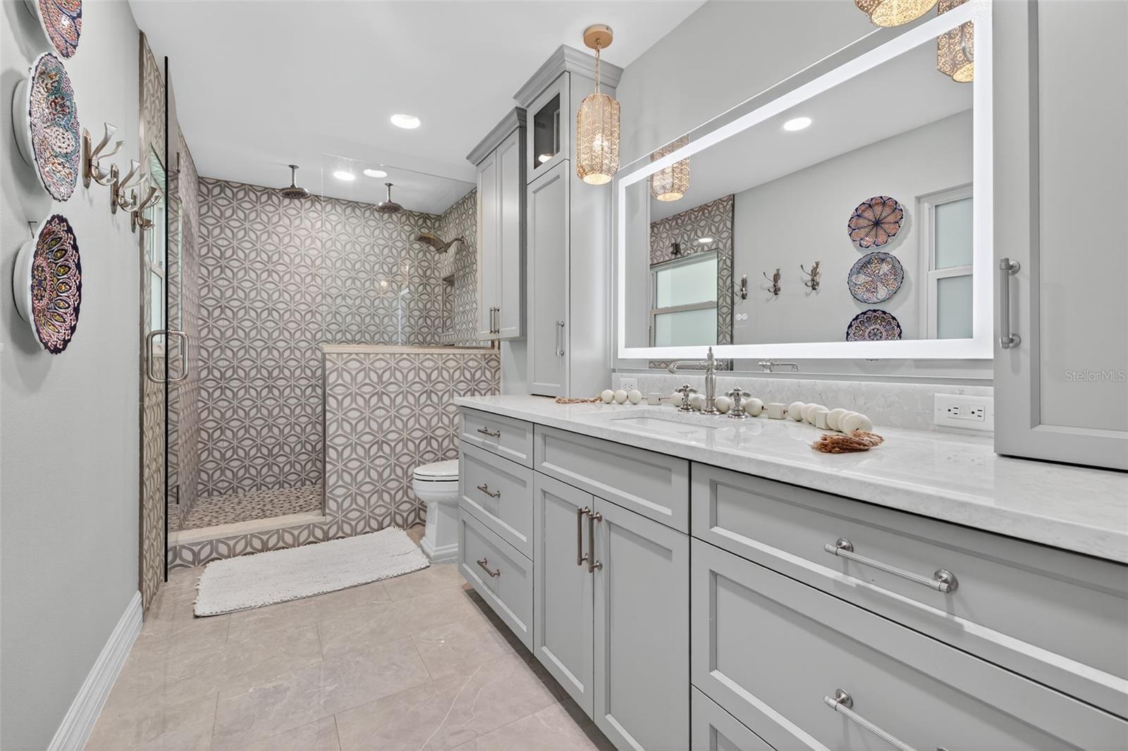 Primary Bathroom with 3 rain-shower heads, docking cabinets for bathroom appliances and vanity with plenty of drawers and cabinet space