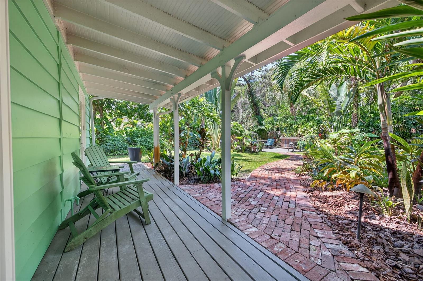Back porch with view of the Tropical Oasis in the Backyard.