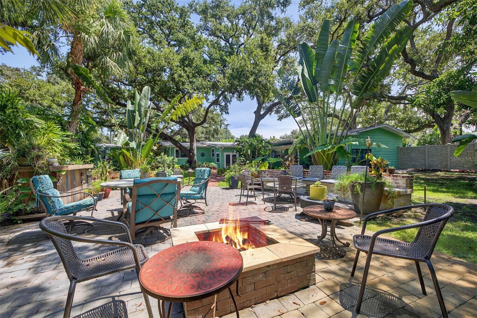 Plenty of seating for entertaining large groups. Firepit and bar