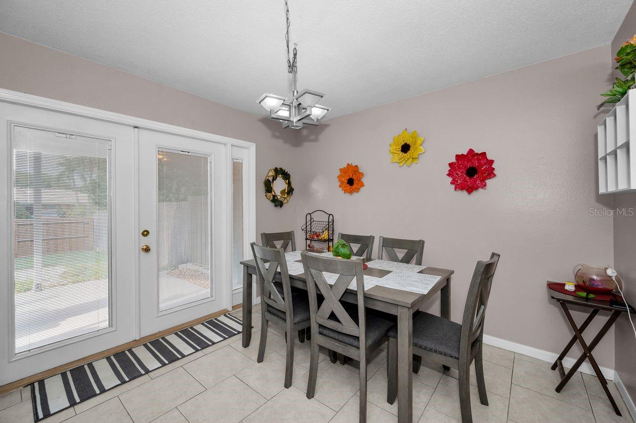 French doors open to covered patio off the dining area