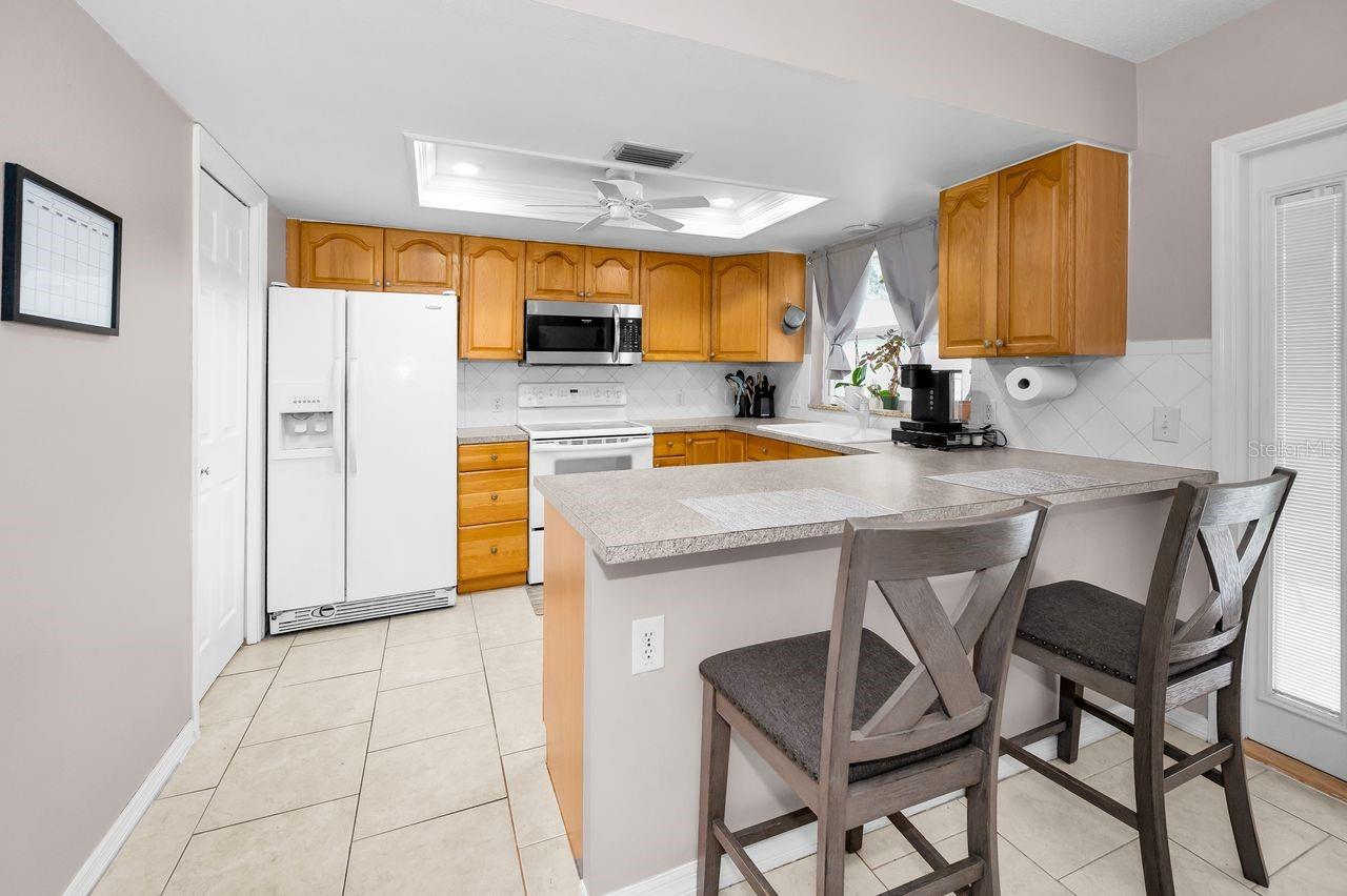 Counter top dining, plenty of light and spacious. Laundry through doorway on left.