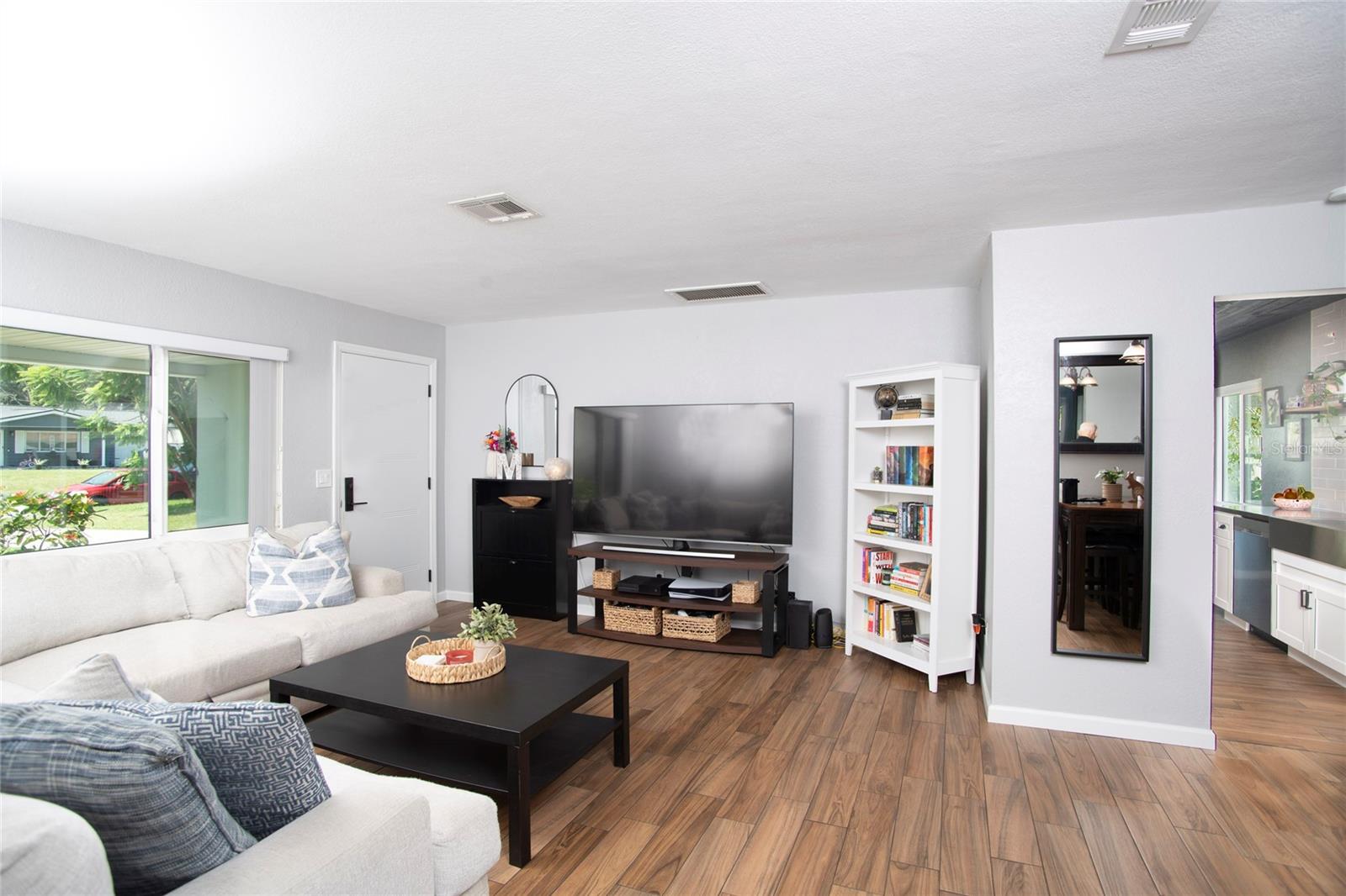 The living room with a peak to the kitchen area.