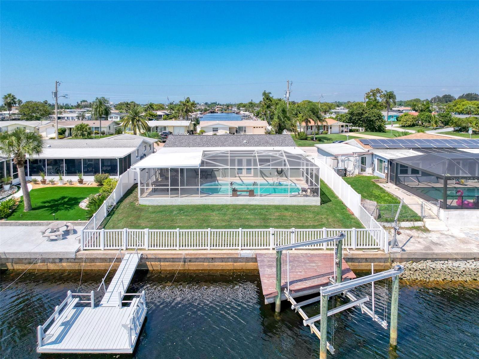 FLOATING DOCK, LIFT, POOL, FENCED IN YARD AND NEVER FLOODED.