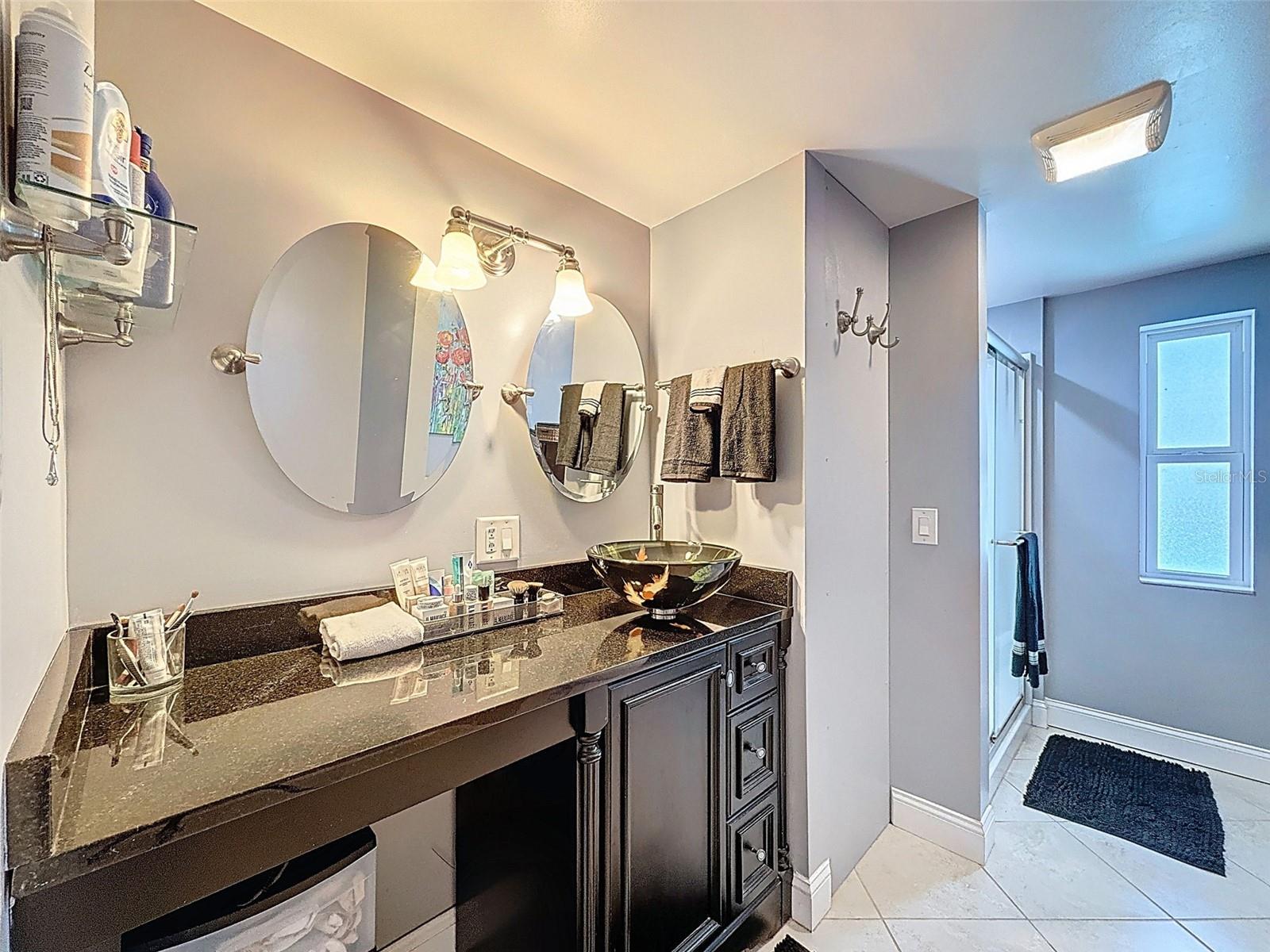 MASTER BATHROOM WITH MAKE UP AREA AND VESSEL SINK.