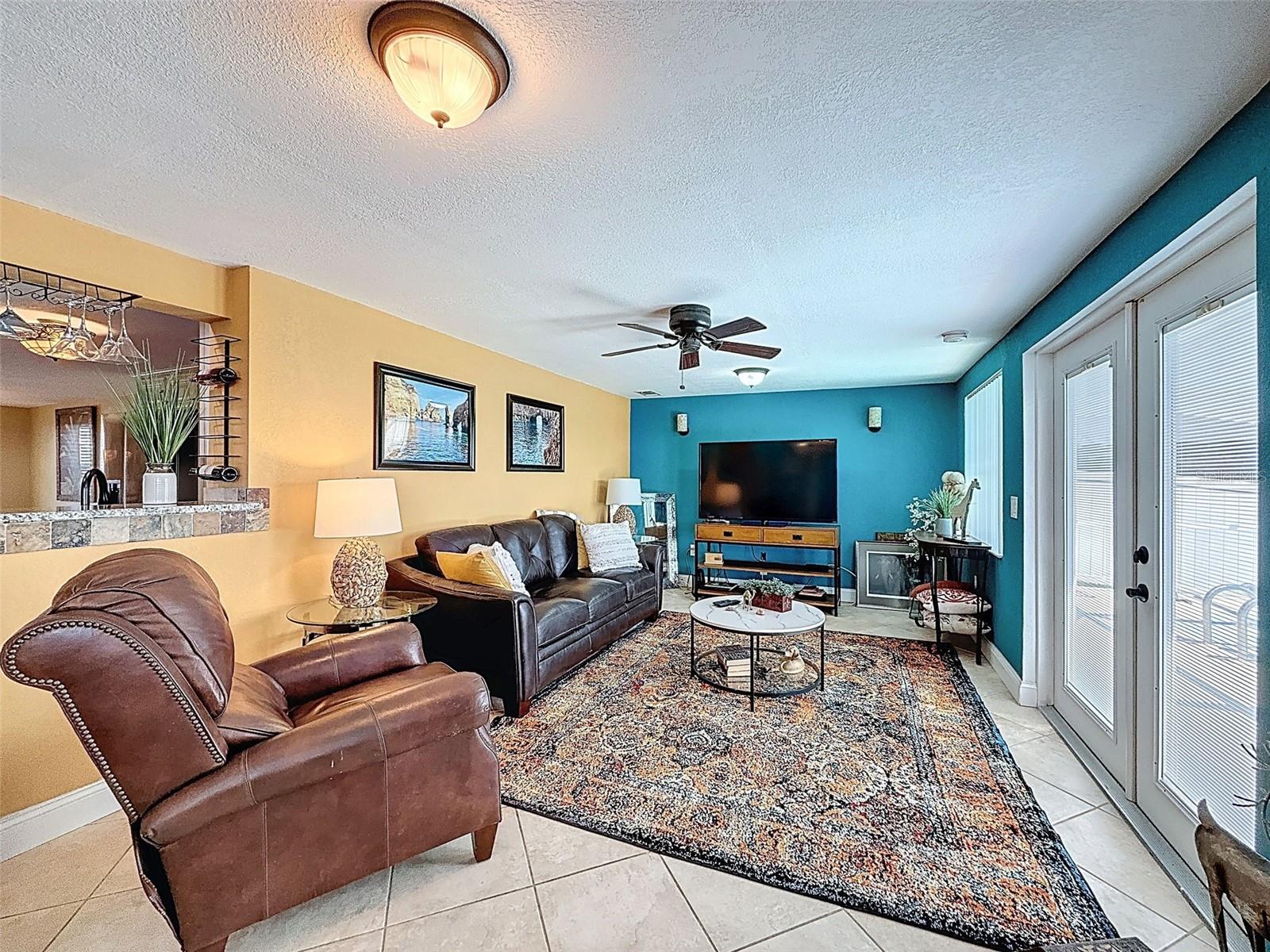 FAMILY ROOM THAT OPENS TO THE POOL WITH FRENCH DOORS