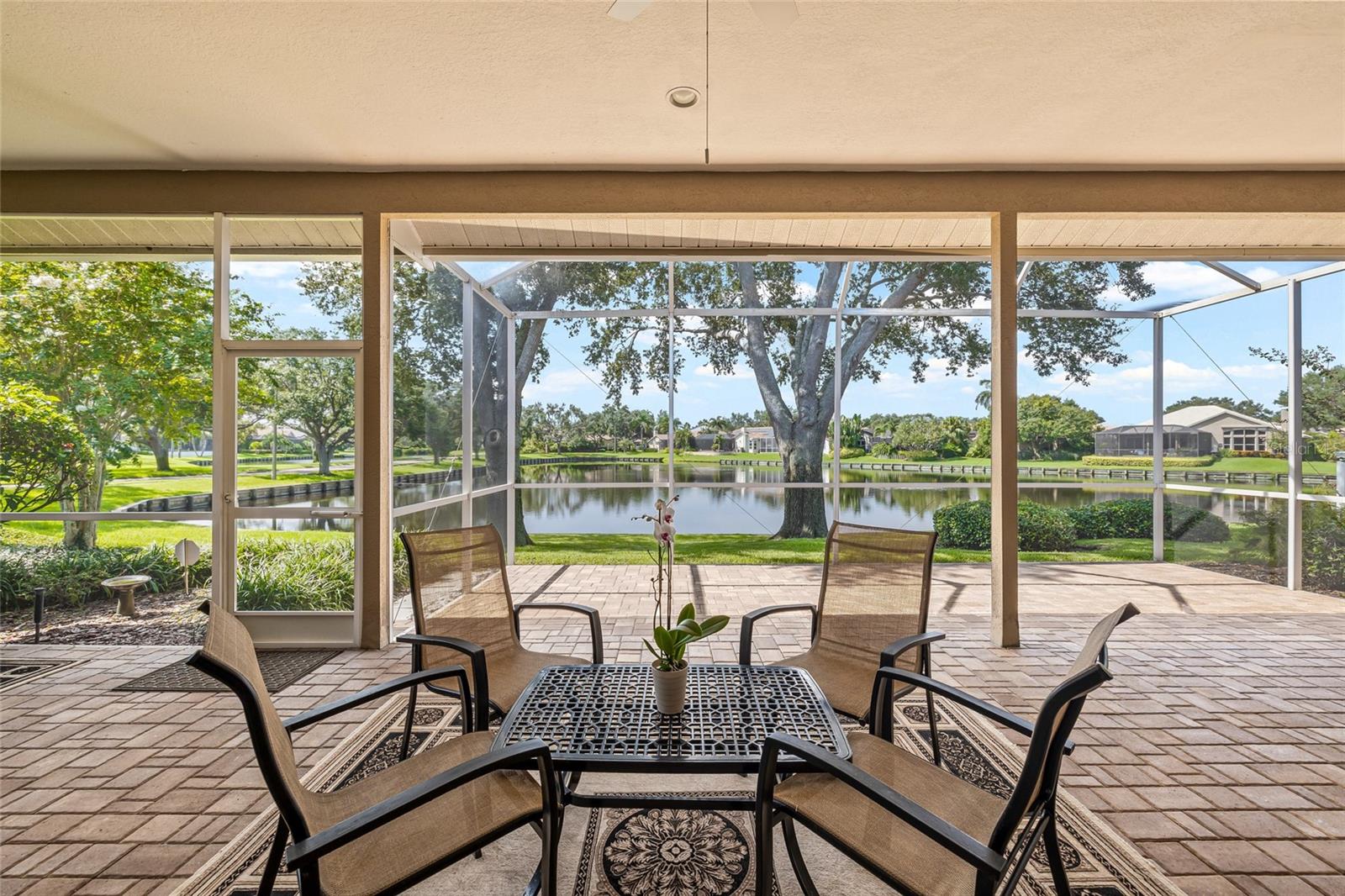 Screened lanai with artisan pavers.