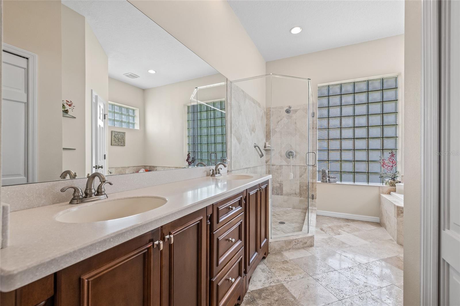 Gorgeous primary suite with step-in shower and separate tub.