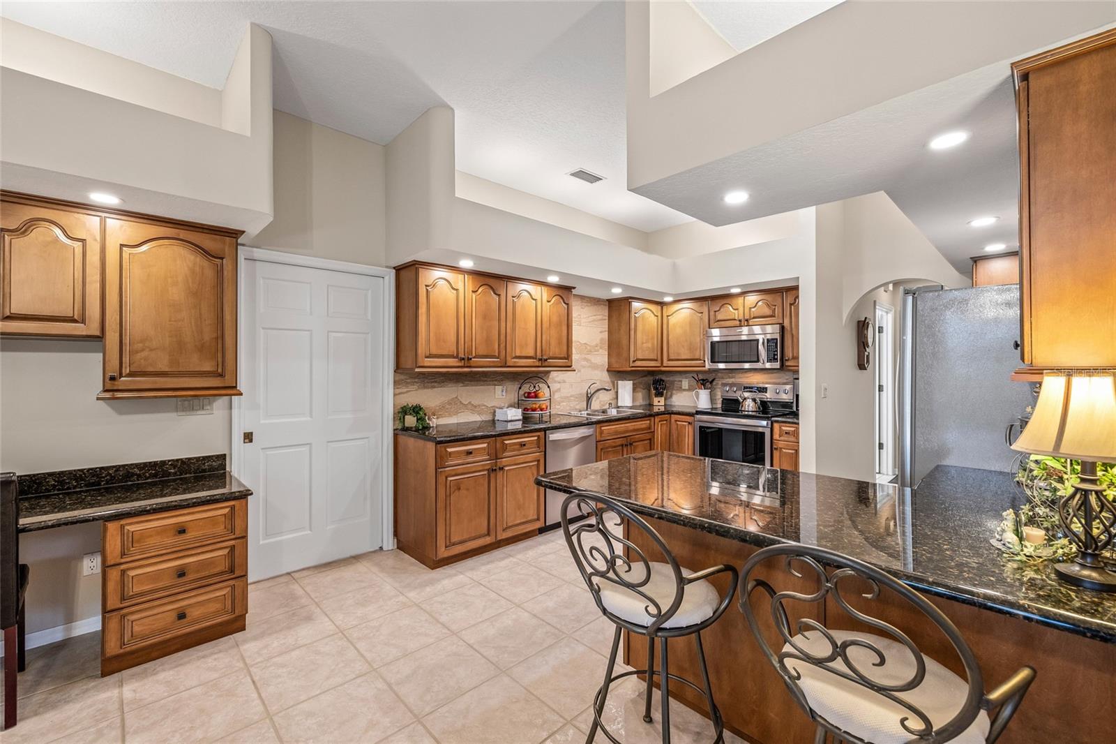 Two additional guest bedrooms and a full bathroom await behind the pocket door in the kitchen.