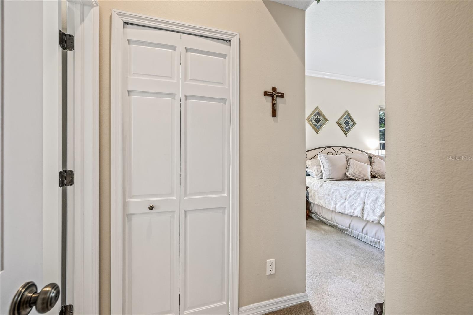 The door straight ahead is the entrance to the large walk-in closet in the primary bedroom.