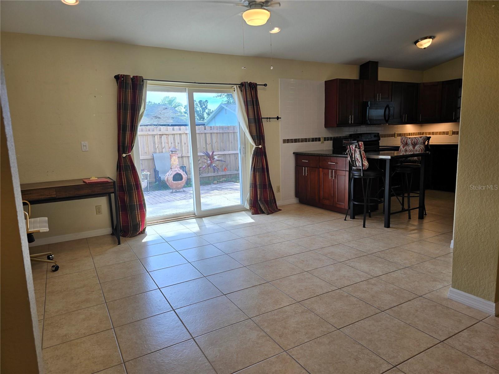 Dining area looks to back yard and divides kitchen, then master bedroom is to the left