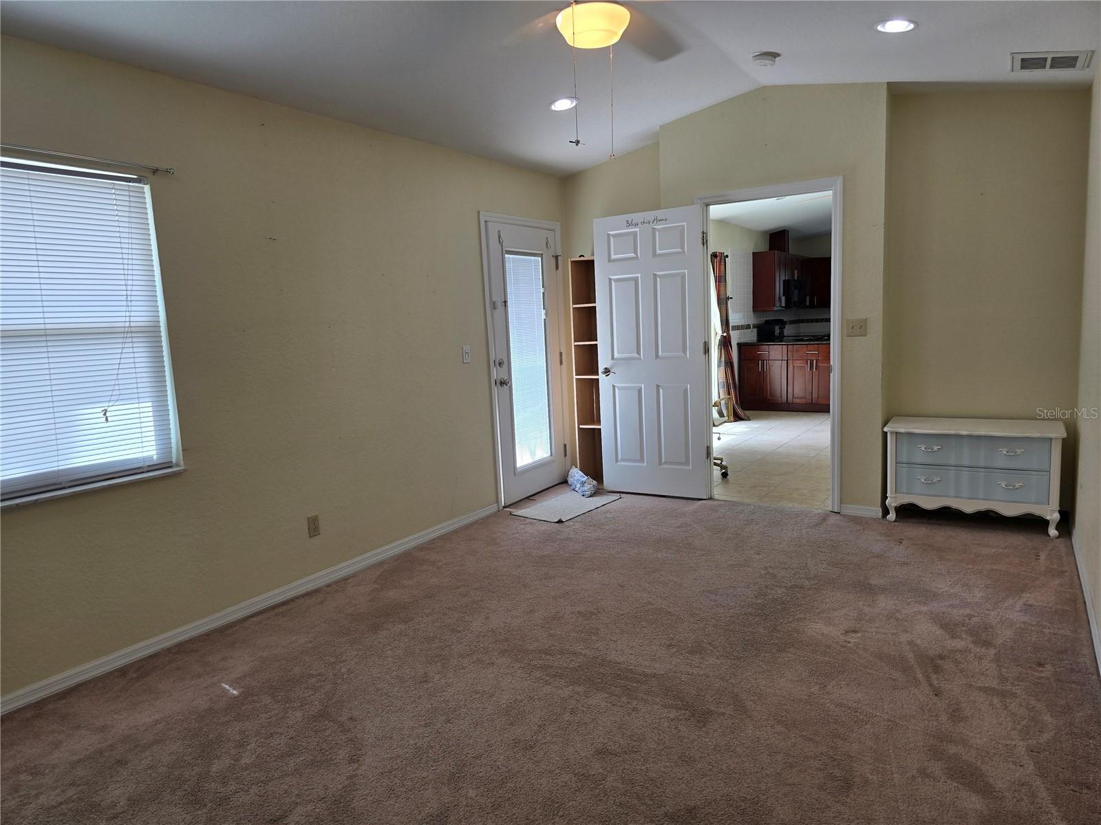 Primary bedroom, door to dining area and kitchen
