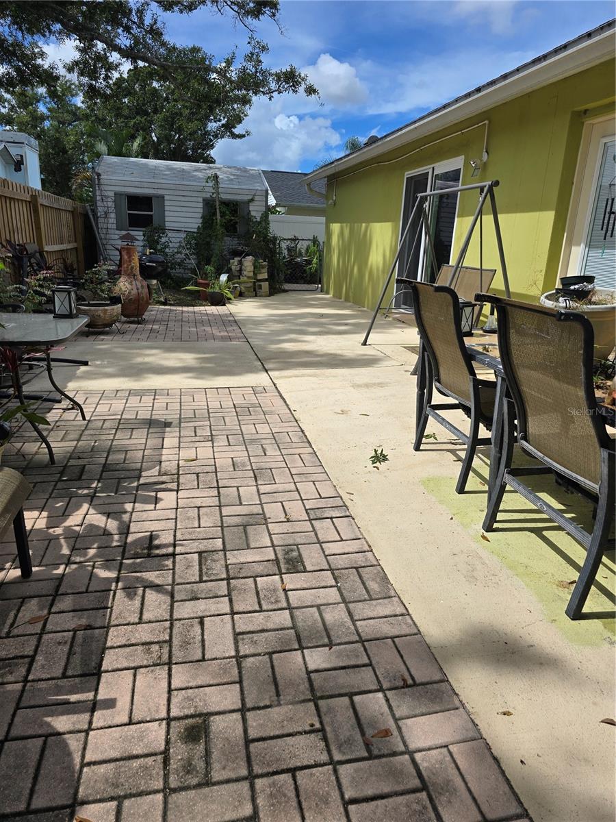Looking west in back yard - you can see shed, and the sliding doors in dining area to the outside. Look close on right and you can see door to primary bedroom
