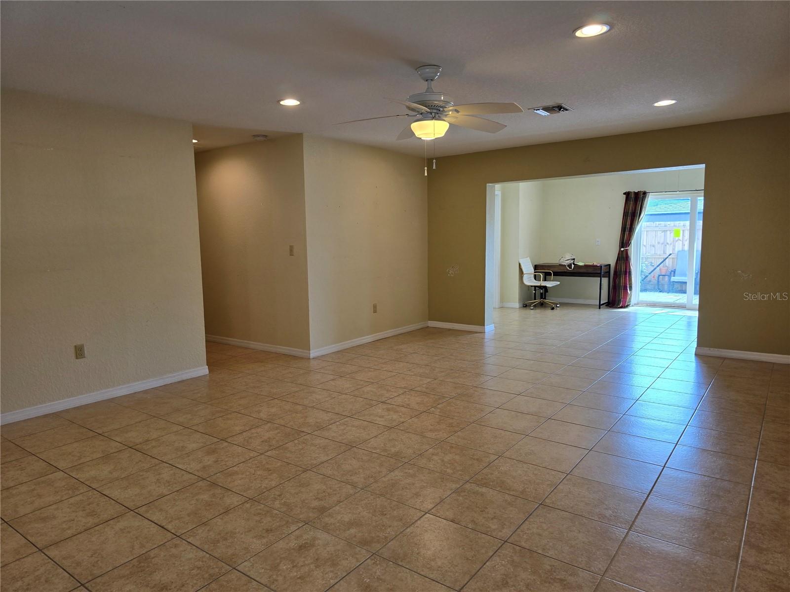 Living area from other front side of home, look back at sliding doors, towards Master Bedroom in back