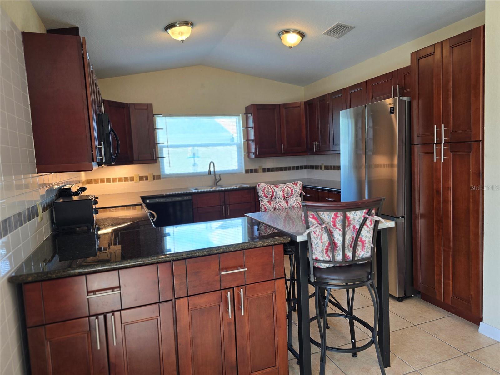 Kitchen, cabinetry abounds. Small two top table can stay at ed of counter or move