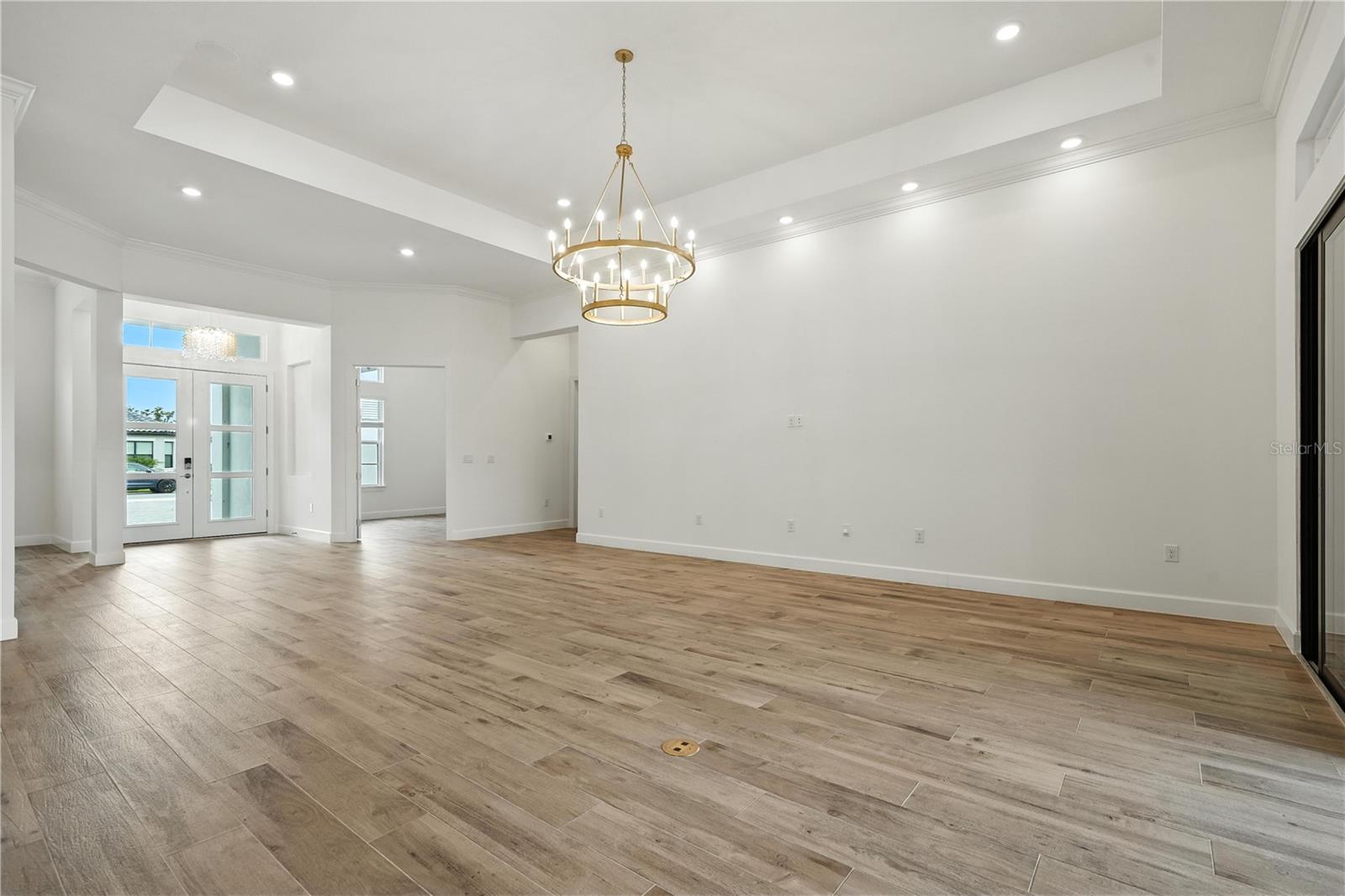 Living Room with Tray Ceilings to Front Door