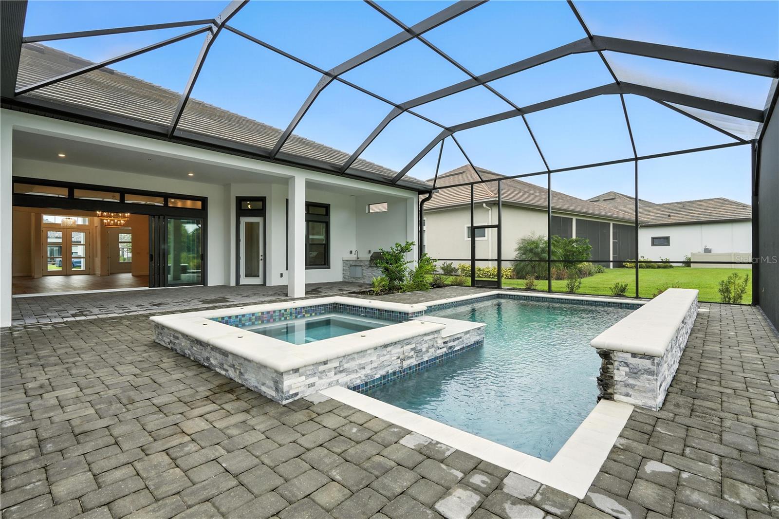 Pool and Spa back into home with outdoor kitchen